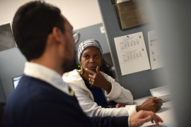 Woman talks to health insurance navigator at desk