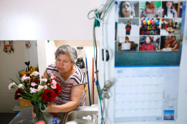 Photo, woman with flowers behind calendar