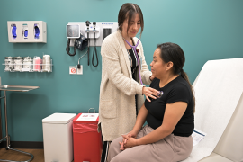 Medical professional listens to patients chest with stethoscope