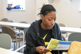 Photo, woman reading pamphlet