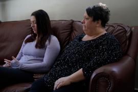 Mother and daughter sitting on a couch