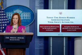 Jen Psaki at white house podium in front of sign