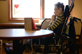 Elderly woman uses tablet to chat with family from wheelchair