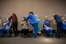 Healthcare workers receiving vaccine in line