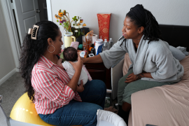 Mom and baby are examined by postpartum professional