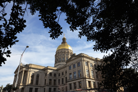 Side view of state capitol building from under a tree