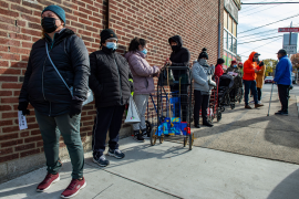 People wait to receive food at La Colaborativa Food Pantry in Chelsea, Mass., on Nov. 23, 2021. To account for social risks, the Massachusetts Delivery System Reform Incentive Payment Program, launched in 2017, adjusts Medicaid payments based on 27 patient characteristics and the Neighborhood Stress Score, a small-area deprivation index. Photo: Joseph Prezioso/AFP via Getty Images