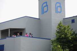 Planned Parenthood employees look on from the balcony to a demonstration outside the Planned Parenthood Reproductive Health Services Center