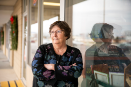 Photo, woman with crossed arms stares off into space